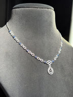 Blue gemstone accents and a teardrop sterling silver pendant
