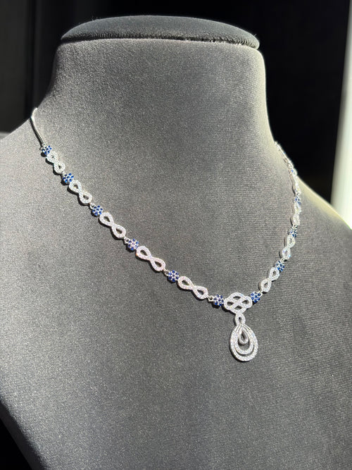 Blue gemstone accents and a teardrop sterling silver pendant