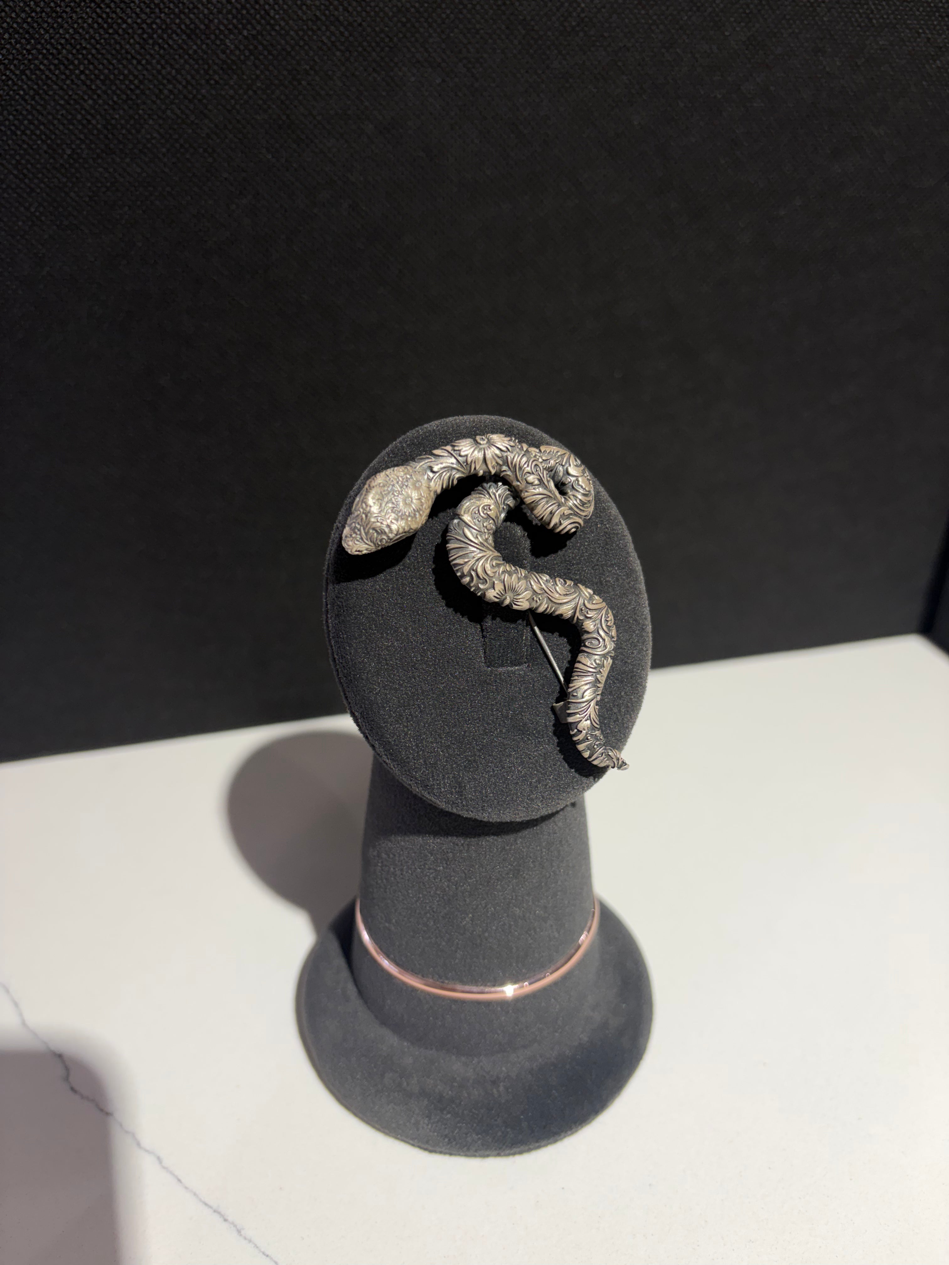 Sterling silver snake brooch with detailed floral engraving